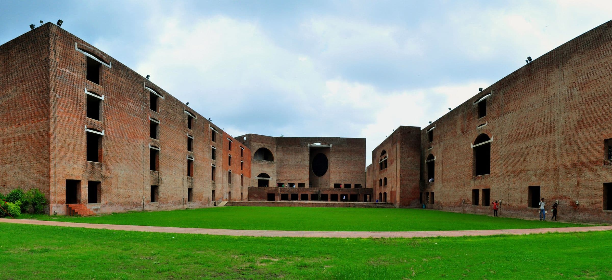 The brick facades and lawn of the Indian Institute of Management, Ahmedabad